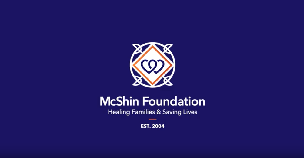 McShin white logo on blue background